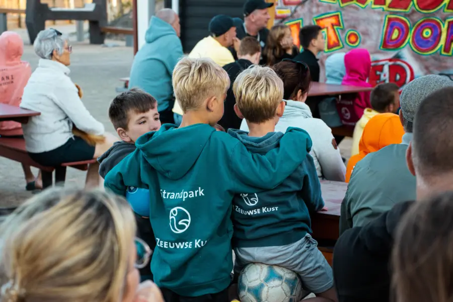 Kinderen genieten van een show en geven elkaar een knuffel